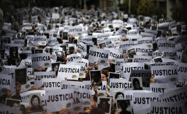 Thousands of people hold up signs reading, "Justice" as they gather to commemorate the 19th anniversary of the 1994 bombing of the Argentine Israeli Mutual Association (AMIA) Jewish community center in Buenos Aires. (Marcos Brindicci/Reuters photo)